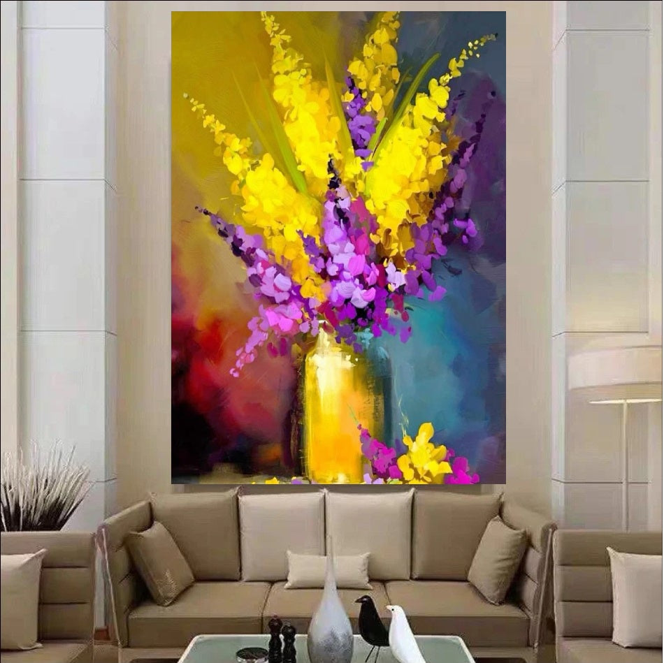 Colorful abstract painting of flowers on a wall above a sofa in a living room.