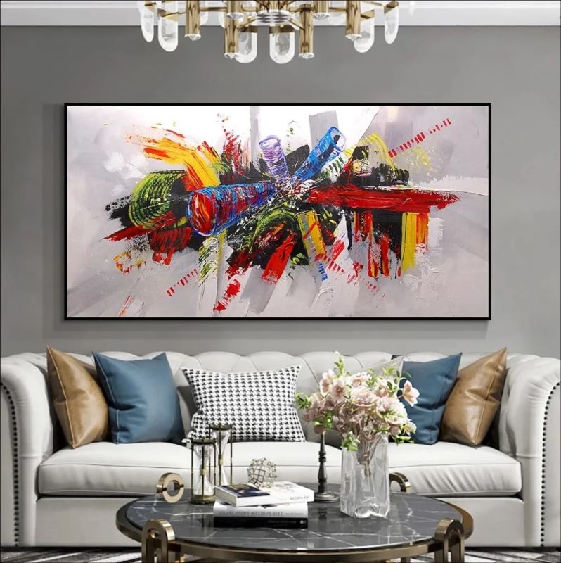 Wide abstract painting featuring a central explosion of bold red, yellow, blue, and green strokes against a white background, modern panoramic wall art style.