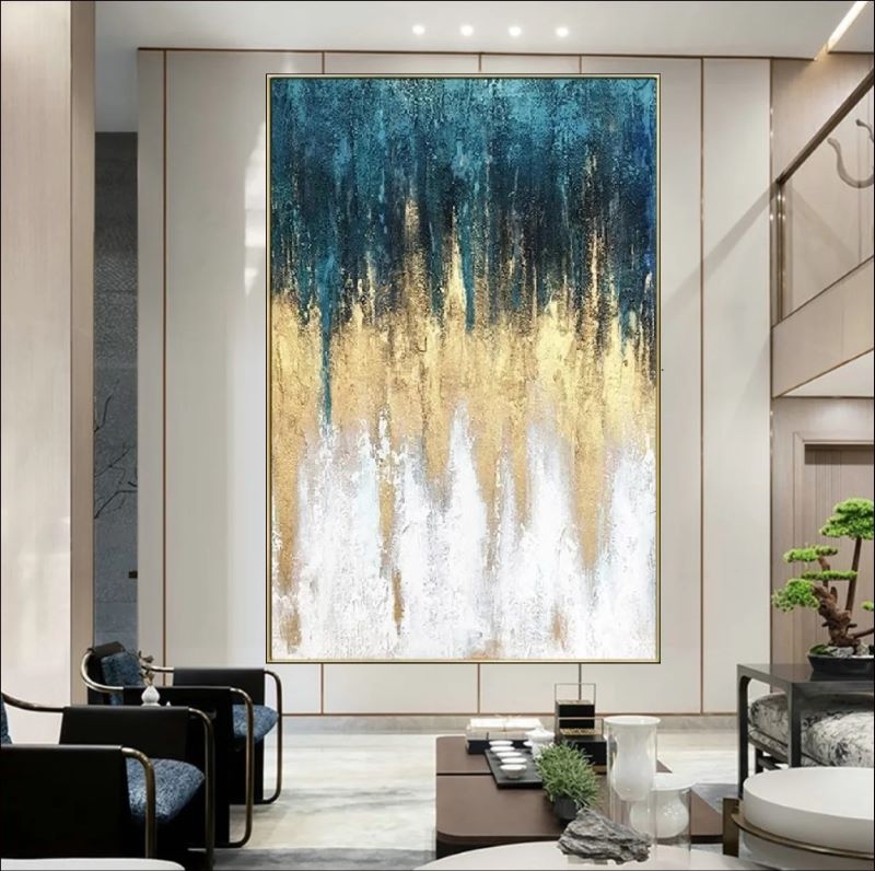 Vertical abstract painting featuring textured rain-like strokes transitioning from deep teal blue to shimmering gold and white, modern luxury wall art style.