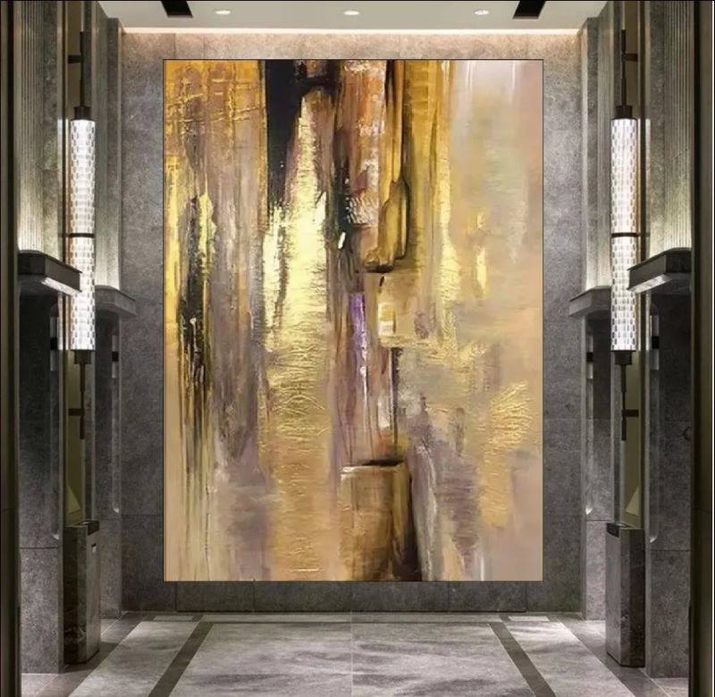 Vertical abstract painting featuring cascading strokes of gold foil, beige, and dark brown textures, modern luxury wall art style.