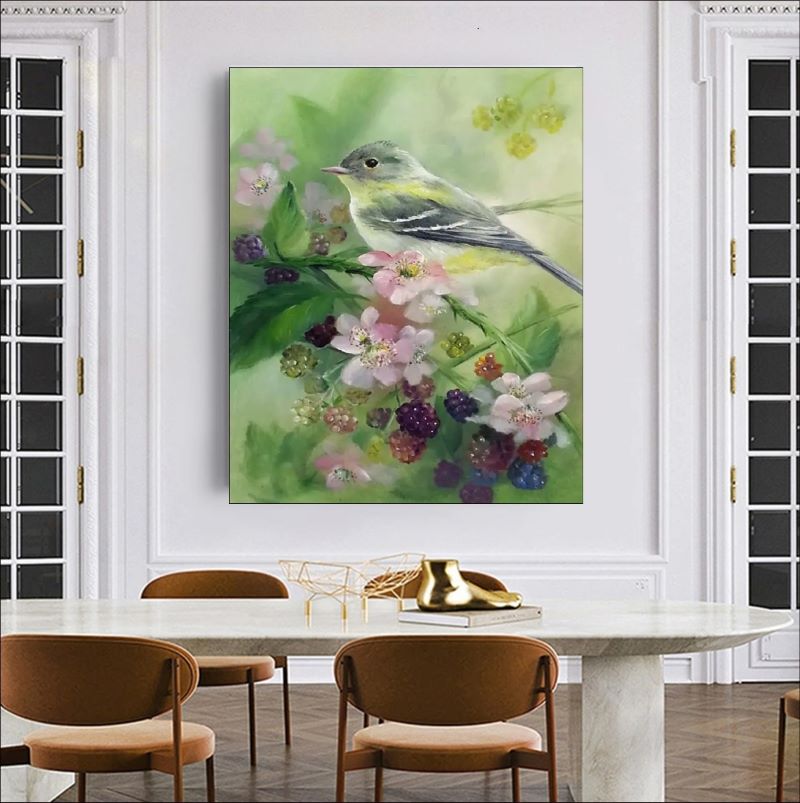 Realistic oil painting of a small grey and yellow songbird perched on a branch with pink blossoms and ripening blackberries against a soft green background.