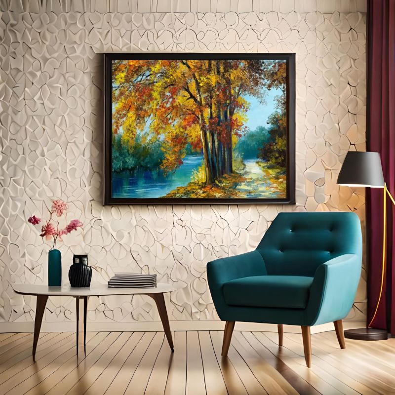 Living room with a blue armchair, table, and framed landscape painting on textured wall.