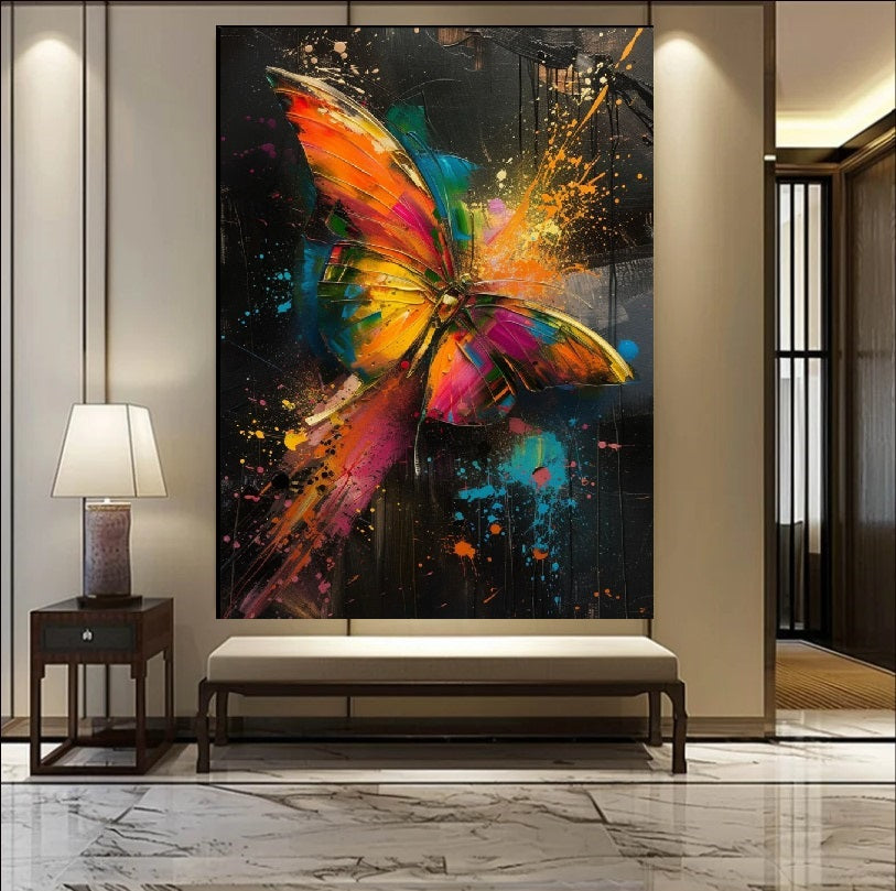 Vibrant abstract painting of a colorful butterfly with neon orange, pink, and blue wings featuring dynamic paint splatters against a dark background, modern art style.