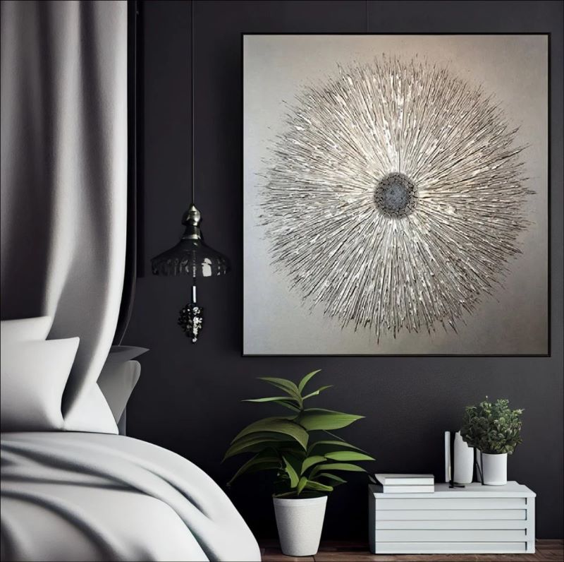 Textured abstract painting featuring a radiant starburst design with raised metallic lines in silver and champagne gold on a neutral background, modern luxury wall art.