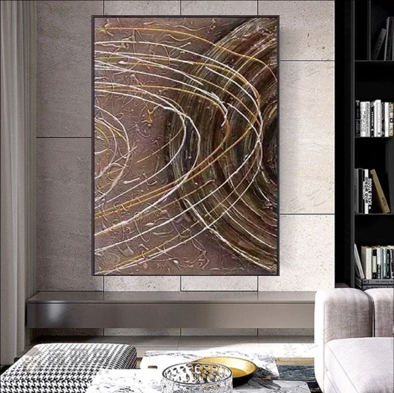 Textured abstract painting featuring deep brown background with dynamic white and gold swirling lines resembling celestial orbits, modern wall art style.