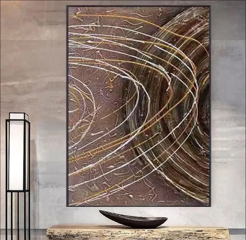 Textured abstract painting featuring deep brown background with dynamic white and gold swirling lines resembling celestial orbits, modern wall art style.