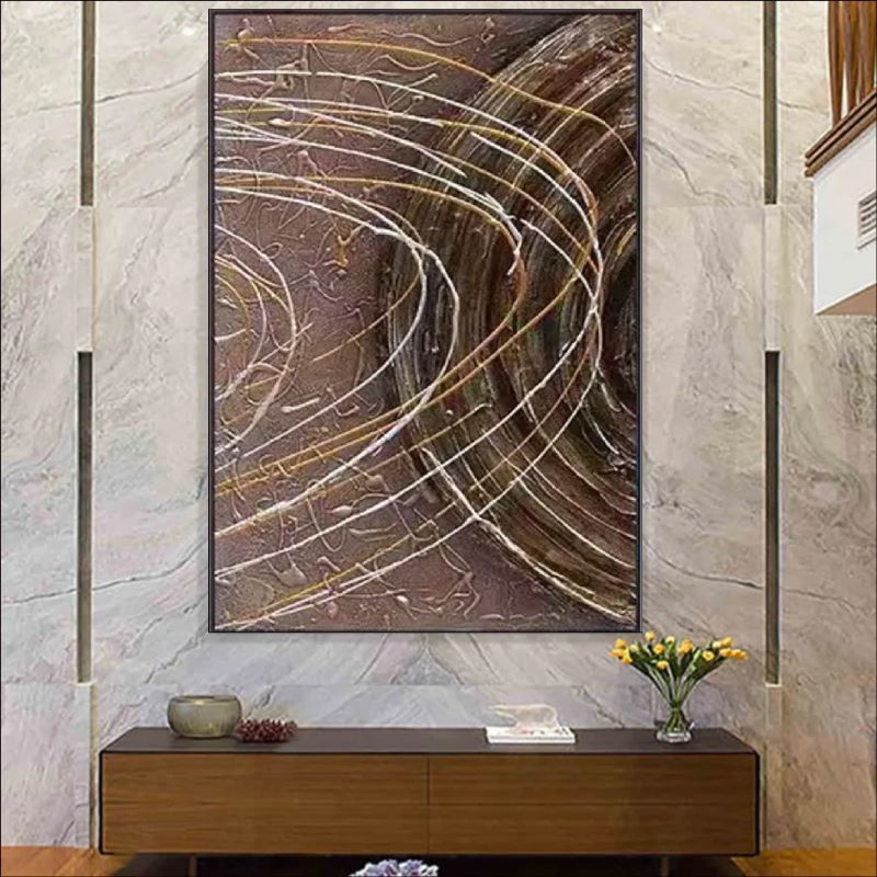 Textured abstract painting featuring deep brown background with dynamic white and gold swirling lines resembling celestial orbits, modern wall art style.