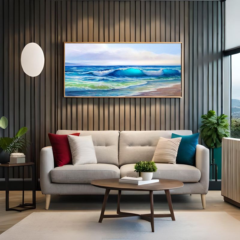 Modern living room with a beige sofa, colorful pillows, and a large framed artwork of a beach scene.