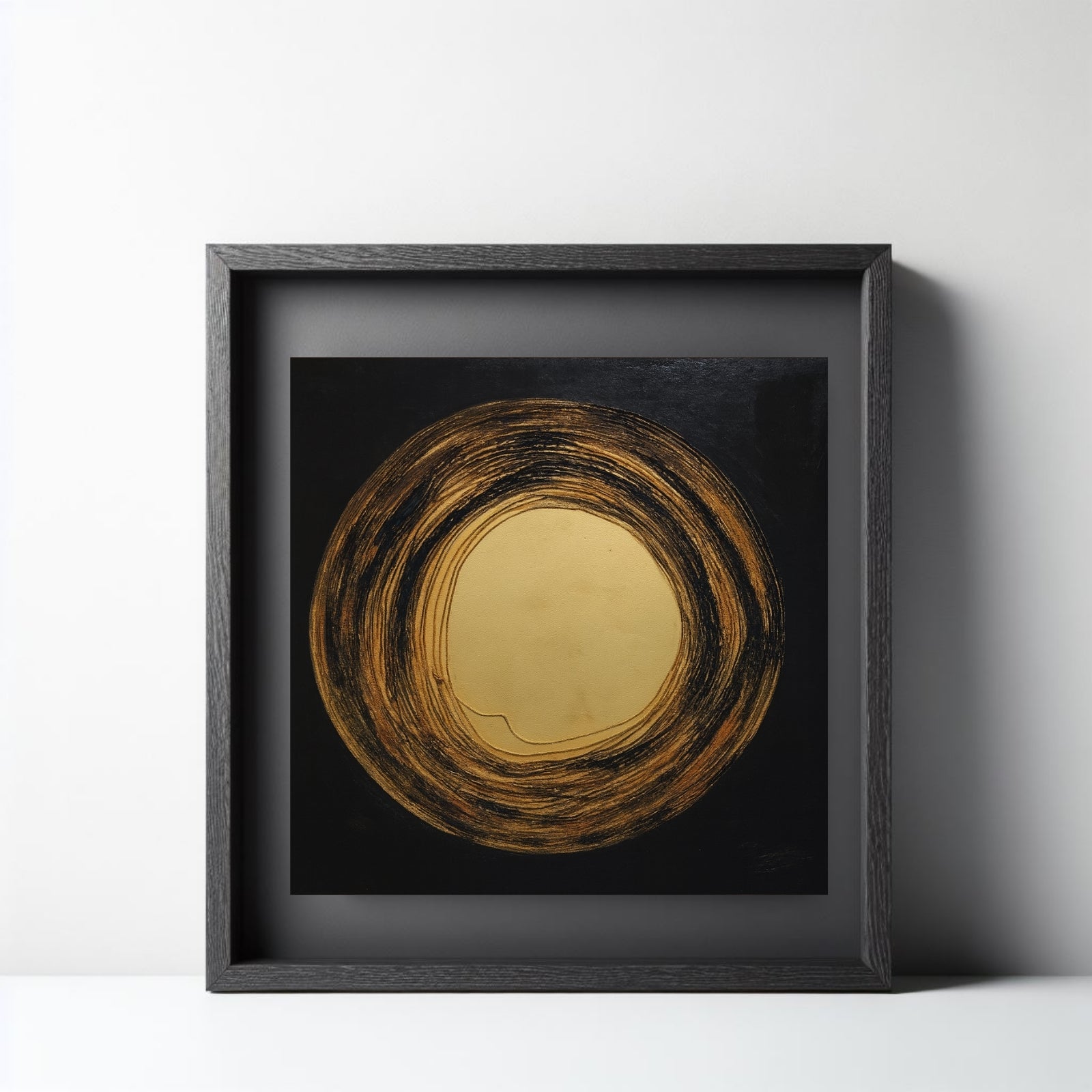 Minimalist abstract painting of a large metallic gold circle surrounded by textured, circular brushstrokes in black and bronze on a dark square canvas.