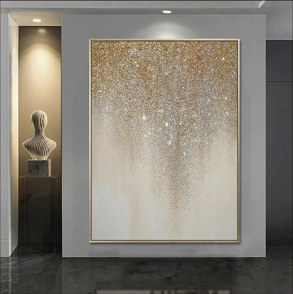 An abstract painting featuring golden glitter cascading in a drip-like pattern on a neutral beige canvas. A luxurious and elegant wall décor piece for modern interiors.