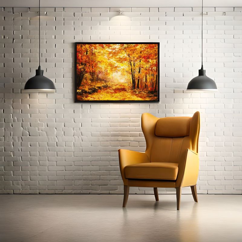 Yellow armchair in front of a white brick wall with a framed autumn landscape painting.