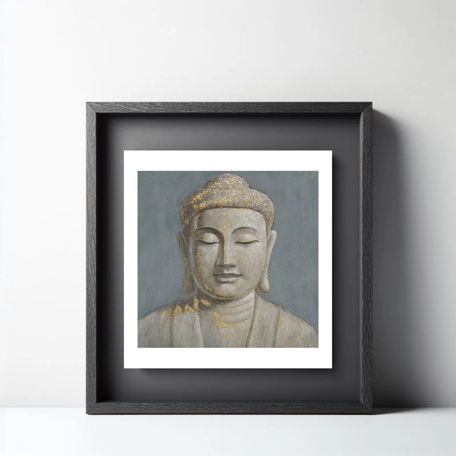 A serene spiritual painting of Buddha's face in a meditative pose, featuring a textured grey background with elegant gold leaf highlights