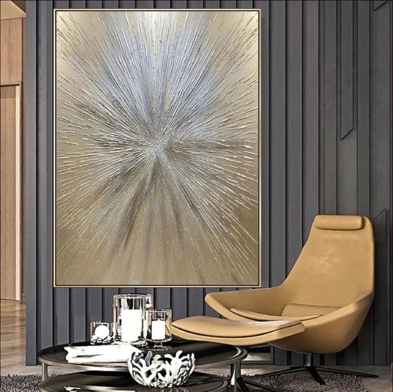 Textured abstract painting featuring a radiant starburst design with raised lines in metallic gold, silver, and champagne tones, luxury wall art style.