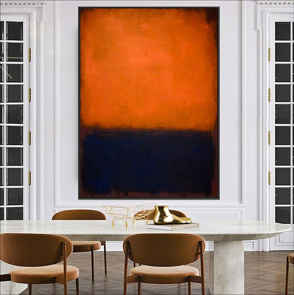 Abstract art piece with orange and black colors on a gray wall, with a lamp and decorative bowl in the foreground.