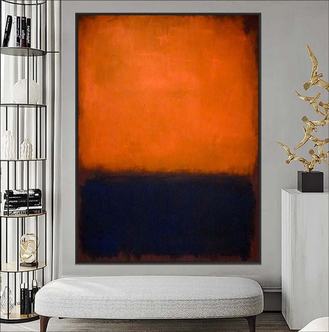 Abstract art piece with orange and black colors on a gray wall, with a lamp and decorative bowl in the foreground.