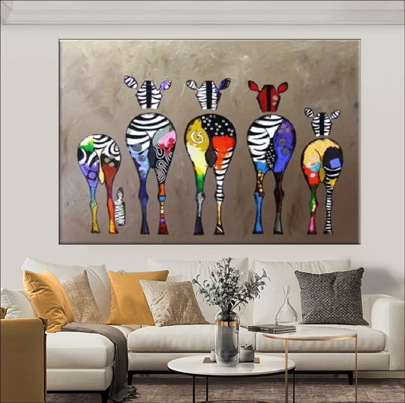 Colorful abstract zebra painting on a wall above a dining table with tea set.