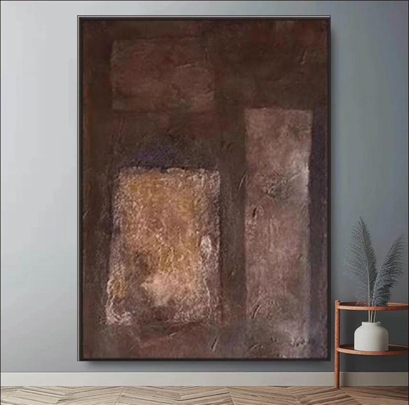 Abstract painting featuring deep brown, rust, and copper block textures hanging above a bed in a modern minimalist room, rustic wall art style.