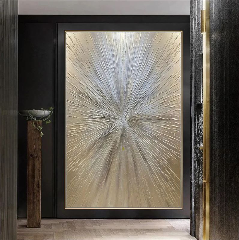 Textured abstract painting featuring a radiant starburst design with raised lines in metallic gold, silver, and champagne tones, luxury wall art style.