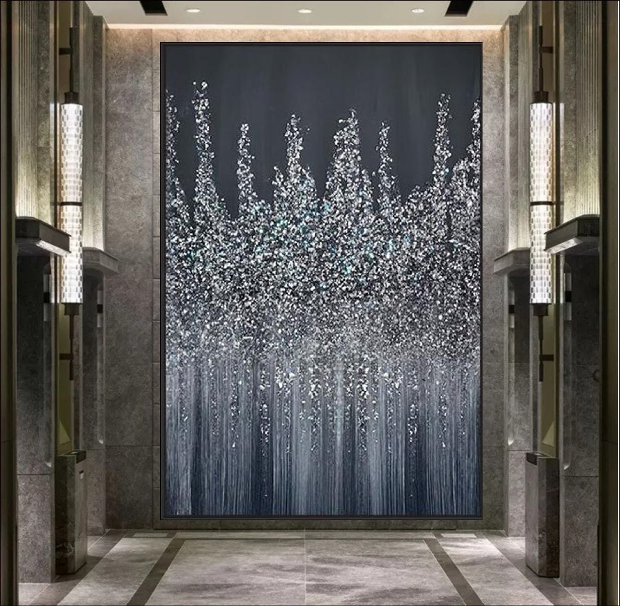 An abstract painting featuring a silver, glittering skyline against a dark midnight background. The artwork showcases a textured design with cascading metallic accents, evoking a sense of elegance and modernity